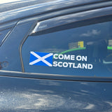 Car window with a Scottish world cup sticker.
