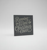 Slate coaster with 'Running on Wine Christmas Cheer' text and wine glass graphic on a gray surface.