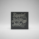 Decorative sign with 'Sippin' on my Jingle Juice' text and a wine glass graphic on a gray background.